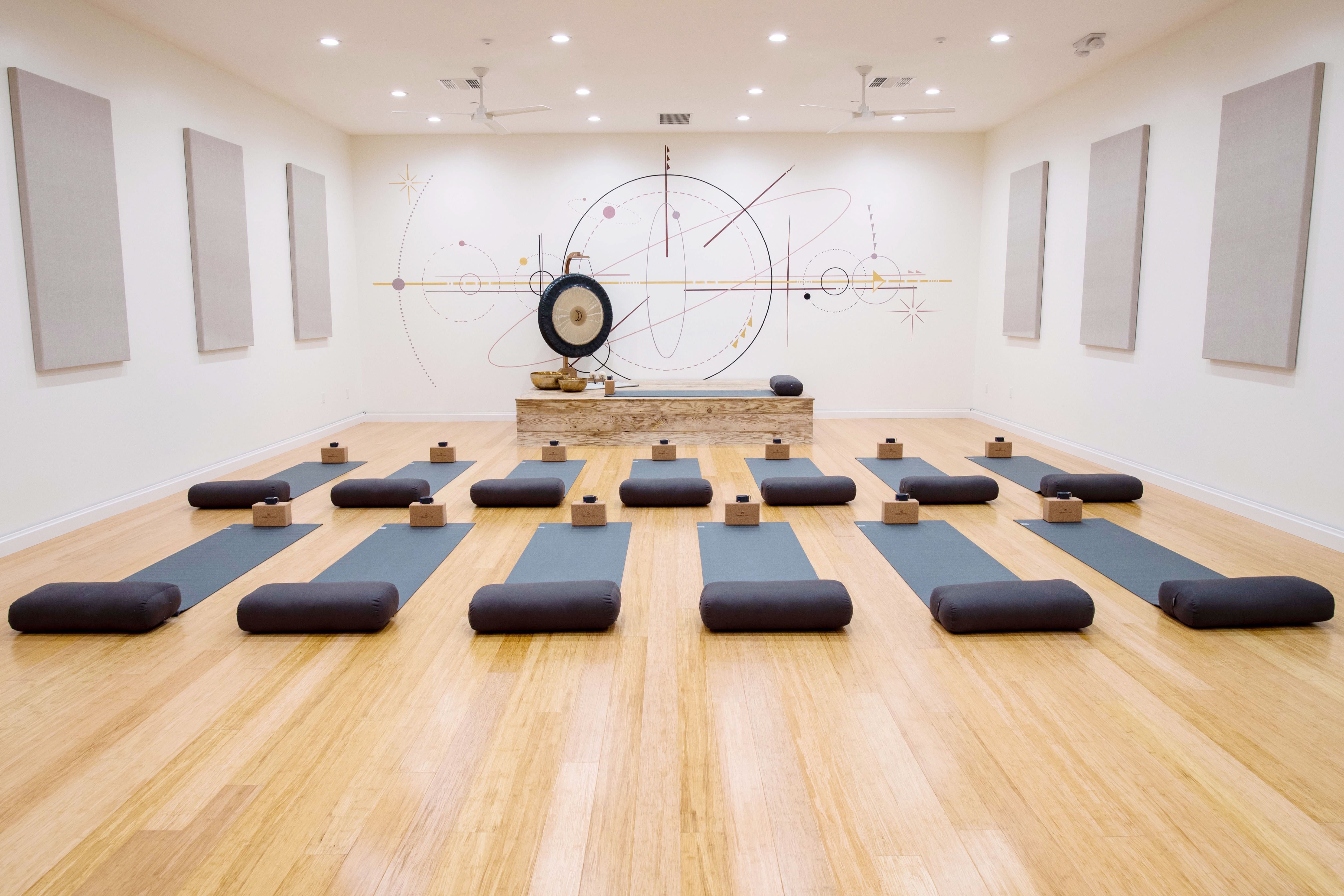 yoga mats lined up in a studio